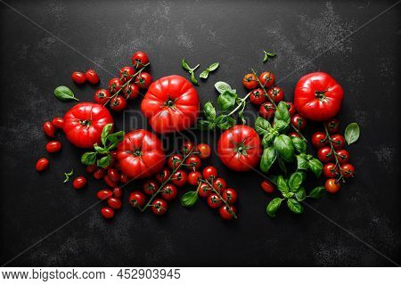 Tomatoes And Basil On Black Background, Top View, Flat Lay