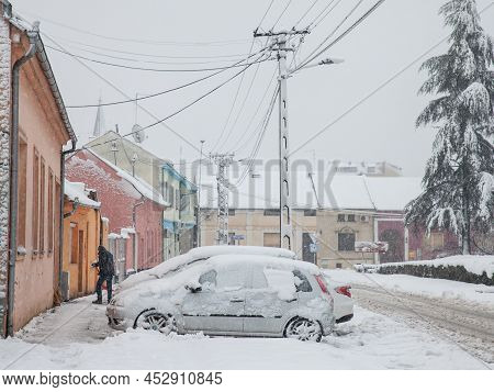 Pancevo, Serbia - December 2021: Selective Blur On A Man Removing Snow With A Snow Showel In The Cit