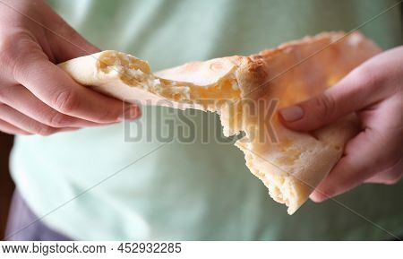 Flour Bun Flatbread In Hands Break Apart. Female Arm Breaking Freshly Baked Bread