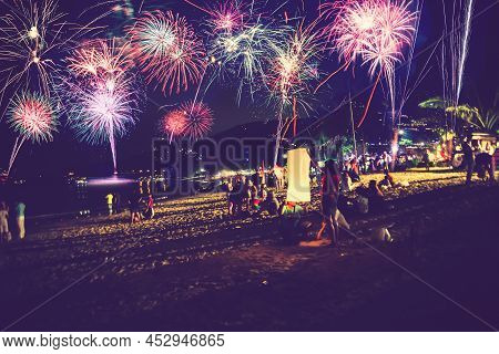 Background Festive New Year With Fireworks And Bokeh. New Year Fireworks On The Beach.