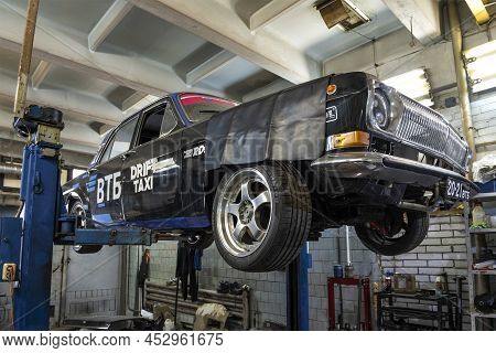 Saint Petersburg, Russia - April 08, 2022: Black Custom Volga Gaz-24 On A Car Lift On A Service Stat