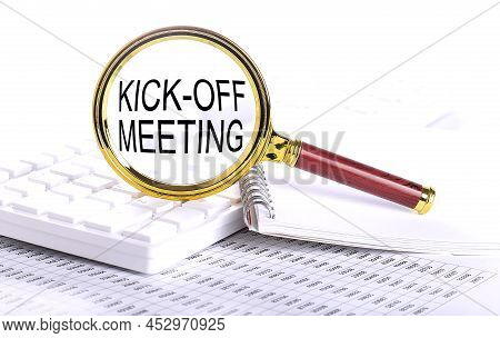 Kick-off Meeting Word Through Magnifying Glass On The Keyboard On Chart