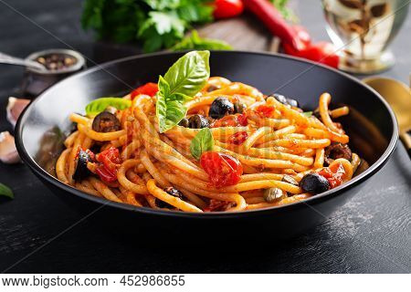 Spaghetti Alla Puttanesca - Italian Pasta Dish With Tomatoes, Black Olives, Capers, Anchovies And Ba