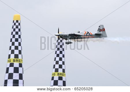 PUTRAJAYA, MALAYSIA - MAY 17, 2014: Hannes Arch from Austria in his Edge 540 V3 plane flies through the race course during the qualifying session of the Red Bull Air Race World Championship 2014.