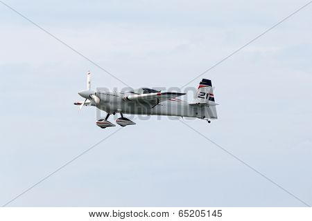 PUTRAJAYA, MALAYSIA - MAY 17, 2014: Matthias Dolderer from Germany flying in an Edge 540 V3 plane flying in the skies of Putrajaya, Malaysia during the Red Bull Air Race World Championship 2014.