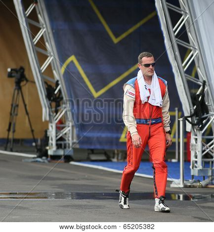 PUTRAJAYA, MALAYSIA - MAY 16, 2014: Pilot Matthias Dolderer of Germany walks back to his hangar after a practice flight preparing for the Red Bull Air Race World Championship Putrajaya 2014.