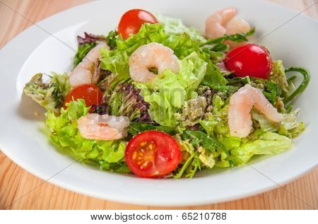 Fresh salad with seefood and tomatoes on the plate