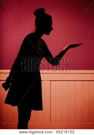 silhouette of a women showing something