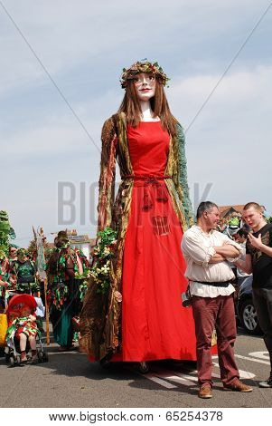 HASTINGS, ENGLAND - MAY 5, 2014: Flora the Singleton Giant is paraded on the West Hill during the annual, May Day, Jack In The Green festival. Pageant Giants are a centuries old tradition in Britain.