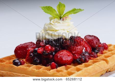 a selection of three italian gelato ice-cream scoops topped with nuts, chocolate, fruit served on crispy waffels