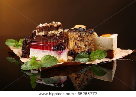 Assortment of pieces of cake, on dark background