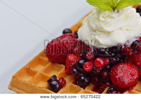 a selection of three italian gelato ice-cream scoops topped with nuts, chocolate, fruit served on crispy waffels