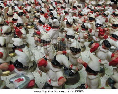 Pulcinella handling traditional naples' object as pizza portrayed in a stall