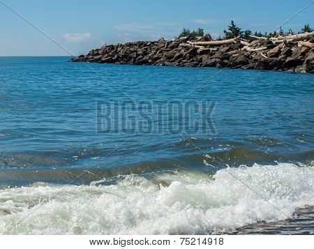 Gentle Beach Waves With A Rock Jetty