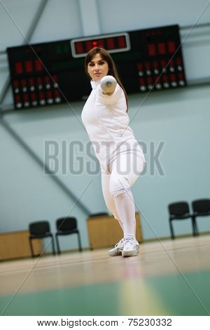 Young woman fencer with epee 