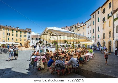 LUCCA, Italy 30 June 2014 people sitting outside at the restaurant on of Piazza Dell Anfiteatro, 30 June 2014 Lucca, Tuscany, Italy, Editorial for only 