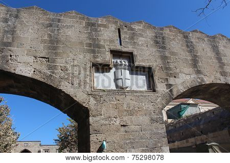 Maltese symbol above arches