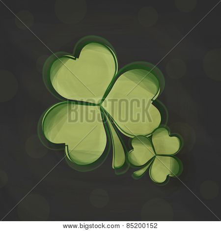 Irish lucky shamrock leaves on black background for Happy St. Patrick's Day celebration.