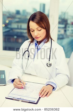 medicine and healthcare concept - busy doctor with laptop computer