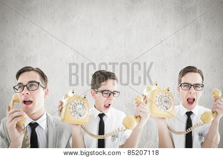 Nerdy businessman with phone against white and grey background