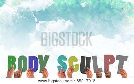 Hands holding up body scuplt against green and blue sky