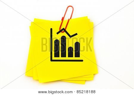 Bar chart against sticky note with red paperclip