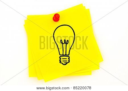 Light bulb against sticky note with red pushpin