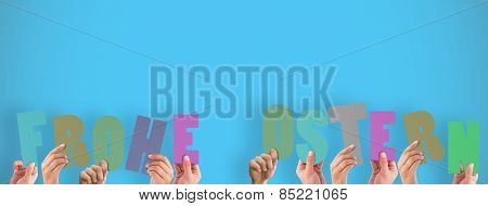 Hands holding up frohe ostern against blue background with vignette