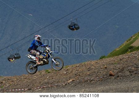 SOCHI, RUSSIA -?? AUGUST 16, 2014: Off-road motorcycle rider trains in summer mountains
