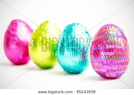 Happy easter in different languages against four easter eggs in a row