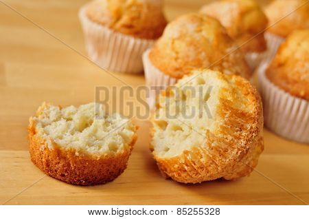 closeup of some magdalenas, typical spanish plain muffins, on a wooden table