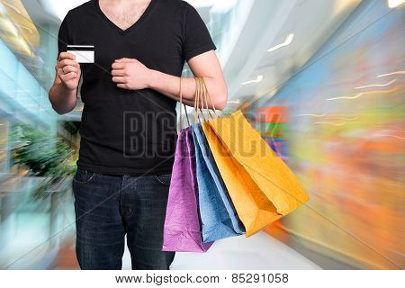 Young Man With Shopping Bags And Credit Card