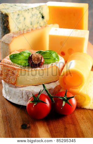 Different Sorts Of Cheese Isolated On Kitchen Table