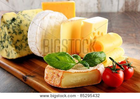 Different Sorts Of Cheese Isolated On Kitchen Table