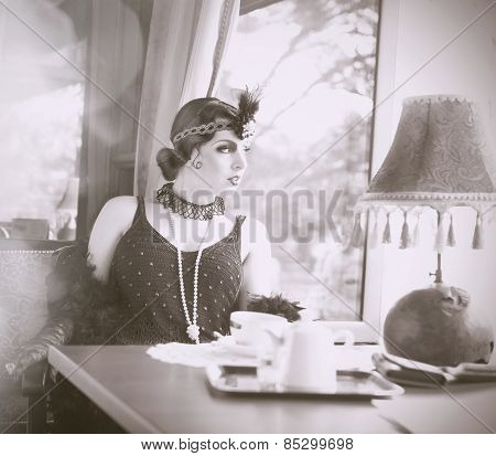 Find Similar  Get A Comp  Save To Lightboxretro Woman 1920S - 1930S Sitting With Cup Of Tea
