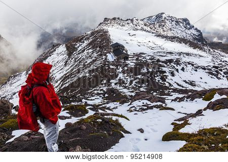 Climber Walking Through Snow, Ice And Rocks.