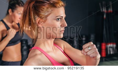 Woman training hard boxing in the gym