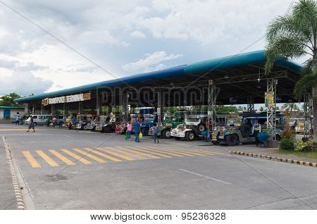 NAGA CITY, PHILIPPINES - JUNE 3, 2015: Colorful jeepneys at a jeepney terminal. Jeepneys are the most popular means of public transportation in the Philippines.