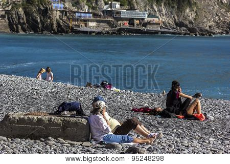 People Relaxing On The Beach In Camogli In Italy