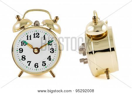Golden mechanical alarm clock isolated