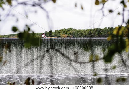 East Providence Rhode Island USA - October 13 2008: Kayaker paddles near edge of Turner Reservoir spillway