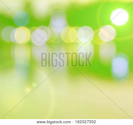 Abstract multicolor blurred bokeh light with water reflection and lens flare effect on green yellow background