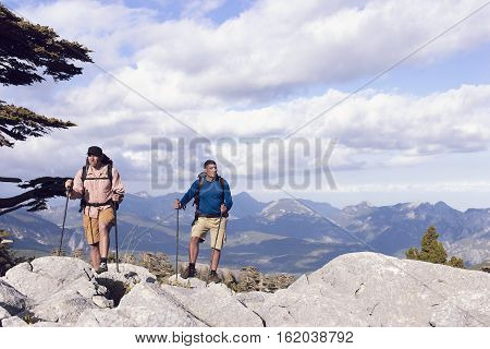 Summer hiking in the mountains with a backpack .