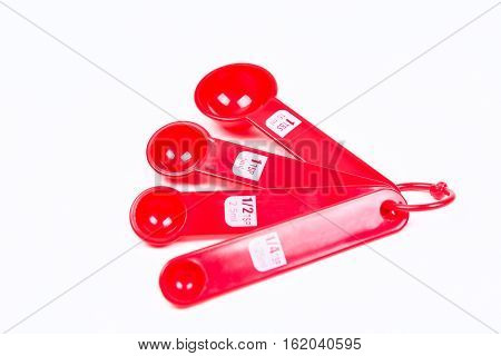Red Measuring Spoons Isolated On White Background