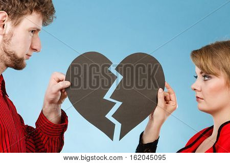 Young Pair Fixing Heart.
