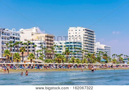LARNACA CYPRUS - AUGUST 27 2016: Finikoudes Beach with the numerous hotels and cafes on the background.