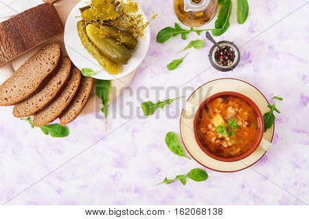 Soup With Pickled Cucumbers And Pearl Barley - Rassolnik On A Light Background. Top View. Flat Lay