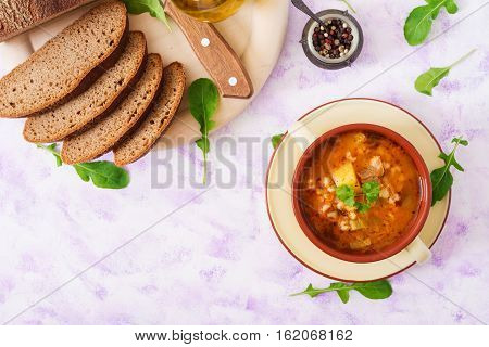Soup With Pickled Cucumbers And Pearl Barley - Rassolnik On A Light Background. Top View. Flat Lay