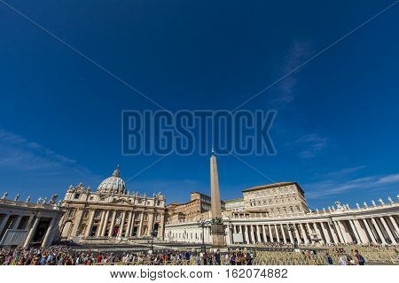 VATICAN - SEPTEMBER 24, 2016: Unidentified people at Saint Peter square in Vatican. Square was designed and built by Bernini between 1656 and 1667.