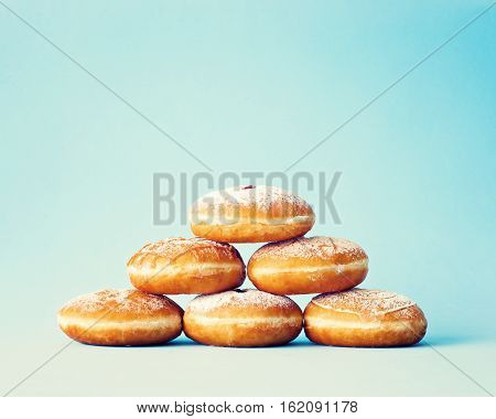 Vintage sugar coated donuts over blue background
